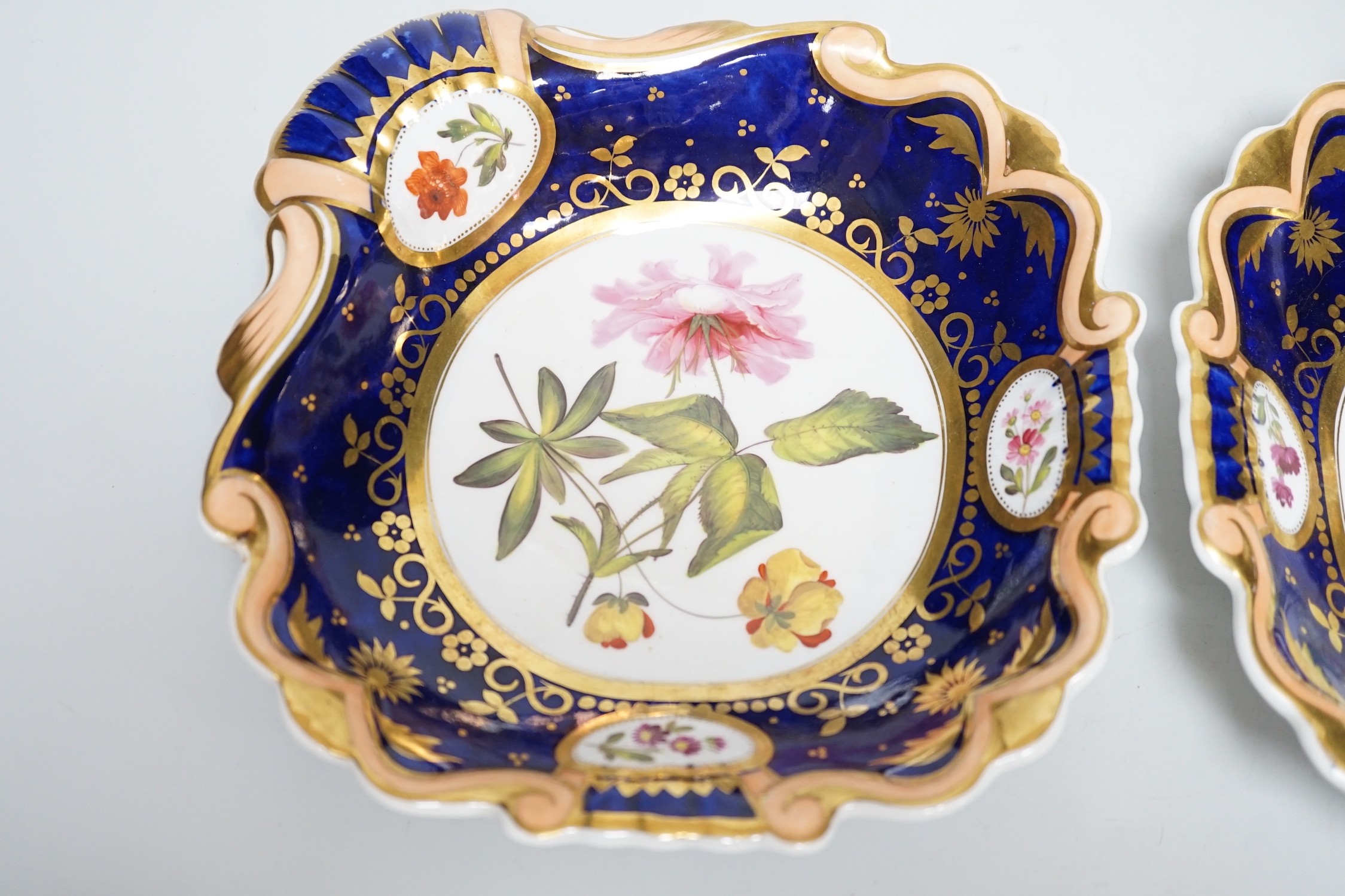 A pair of English porcelain shell shaped dessert dishes, c.1820-25, with floral decoration